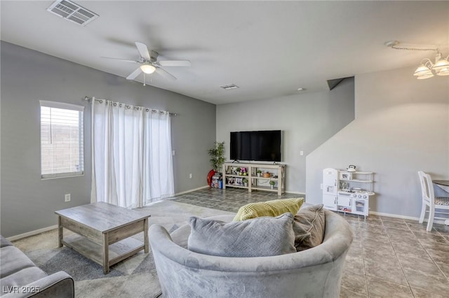 tiled living area featuring baseboards, visible vents, and a ceiling fan