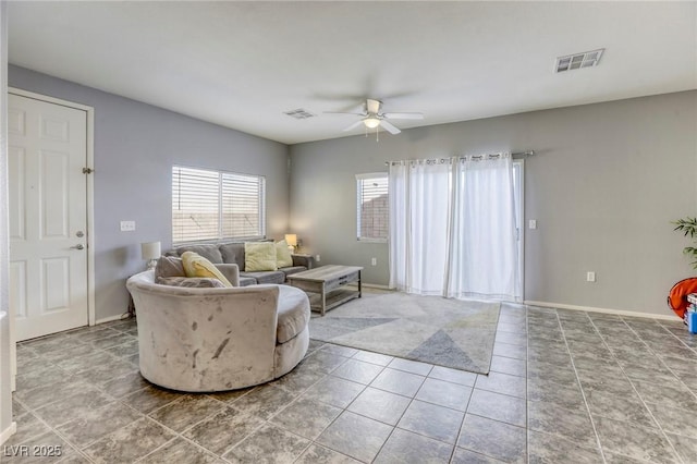 living room featuring baseboards, ceiling fan, visible vents, and tile patterned flooring