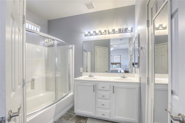 full bath with enclosed tub / shower combo, a sink, visible vents, double vanity, and ensuite bath