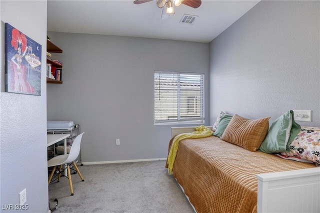 carpeted bedroom with a ceiling fan, visible vents, and baseboards