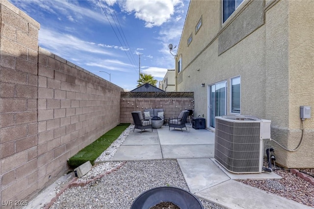 view of patio featuring a fenced backyard, outdoor lounge area, and cooling unit