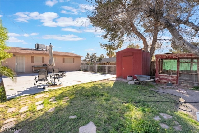 view of yard with central air condition unit, a storage shed, a patio area, a fenced backyard, and an outdoor structure