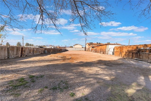 view of yard featuring fence and an outdoor structure