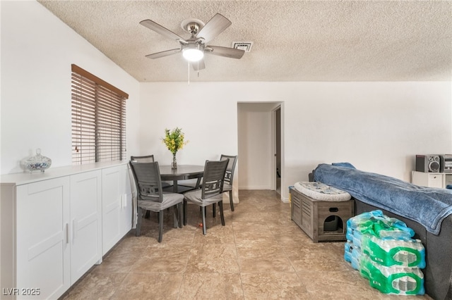 dining space with visible vents, ceiling fan, and a textured ceiling