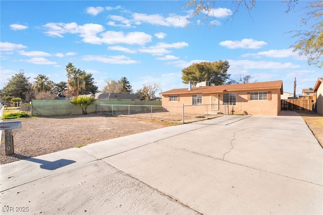 view of front of house featuring fence and stucco siding