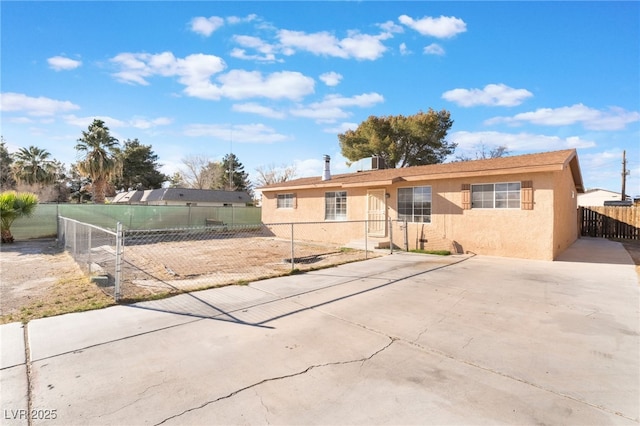 view of front of house featuring fence private yard and stucco siding