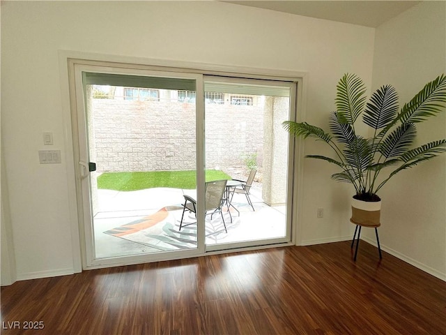 entryway with a wealth of natural light, baseboards, and wood finished floors