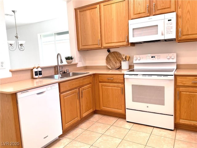 kitchen with light countertops, light tile patterned floors, an inviting chandelier, white appliances, and a sink