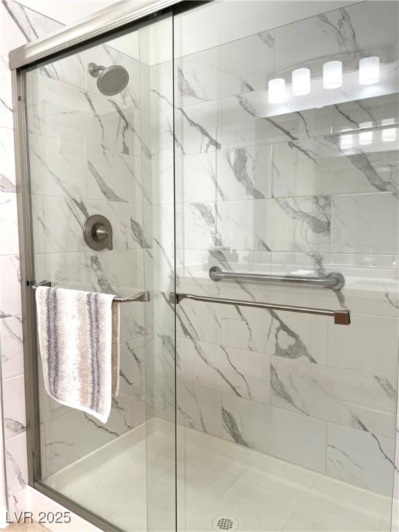 full bath featuring a marble finish shower