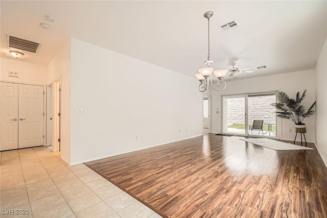 unfurnished room featuring a chandelier, visible vents, and light wood-style floors