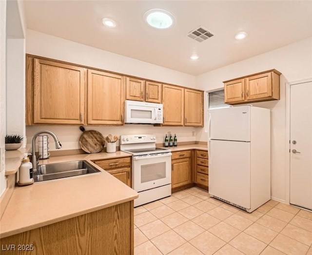 kitchen with white appliances, visible vents, recessed lighting, a sink, and light countertops