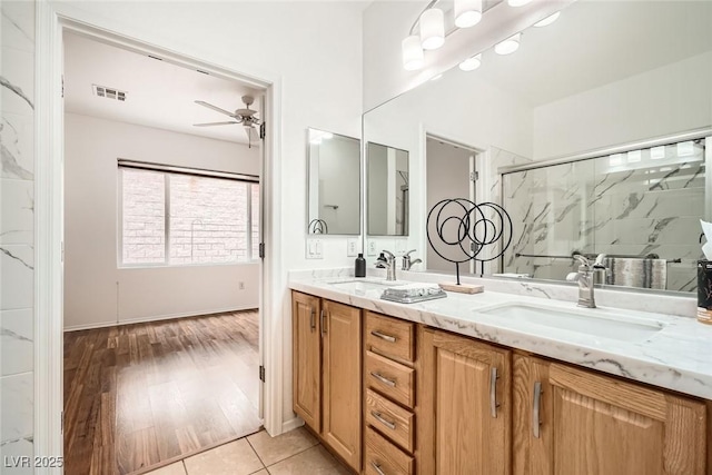 bathroom featuring double vanity, visible vents, ceiling fan, and a sink