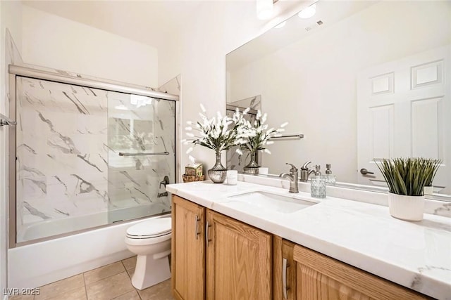 bathroom with tile patterned floors, visible vents, toilet, enclosed tub / shower combo, and vanity