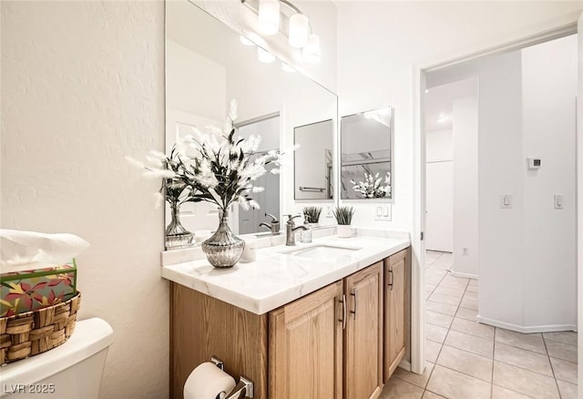 half bath featuring tile patterned flooring, toilet, and vanity