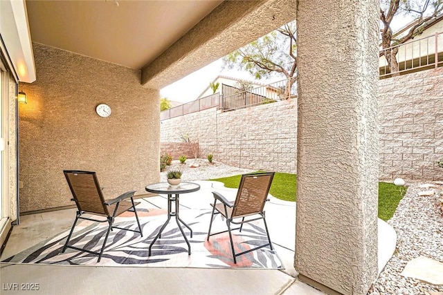 view of patio / terrace featuring fence