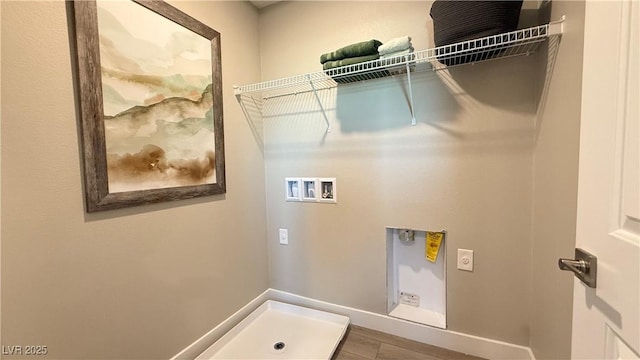 laundry room with washer hookup, hookup for an electric dryer, wood finished floors, laundry area, and baseboards