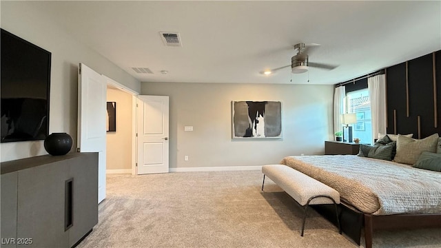 bedroom featuring light carpet, ceiling fan, visible vents, and baseboards