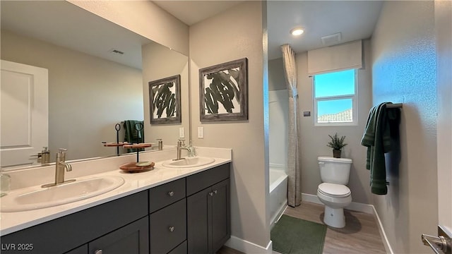 full bathroom featuring visible vents, a sink, toilet, and double vanity