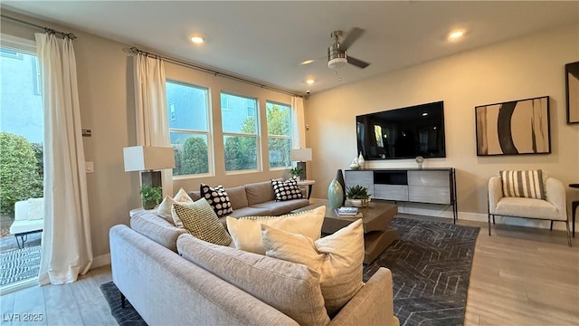 living area featuring recessed lighting, wood finished floors, a ceiling fan, and baseboards