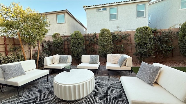 view of patio featuring a fenced backyard and outdoor lounge area