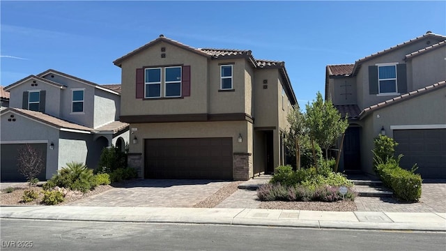 4181 Nopal Serrano Ave, Las Vegas, NV 89141 - view of front of house with an attached garage, stucco siding, decorative driveway, and a tile roof