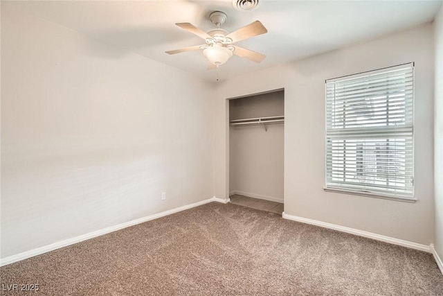 unfurnished bedroom featuring carpet floors, a closet, visible vents, and baseboards