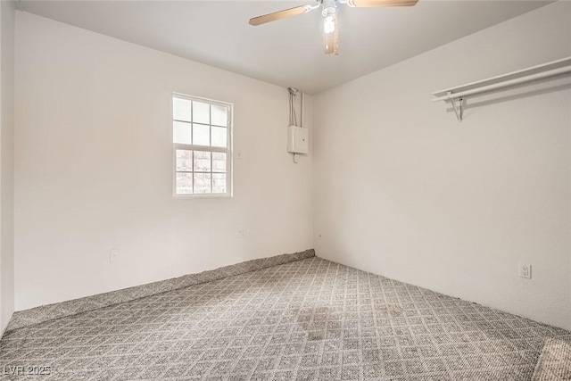 unfurnished room with carpet flooring and a ceiling fan