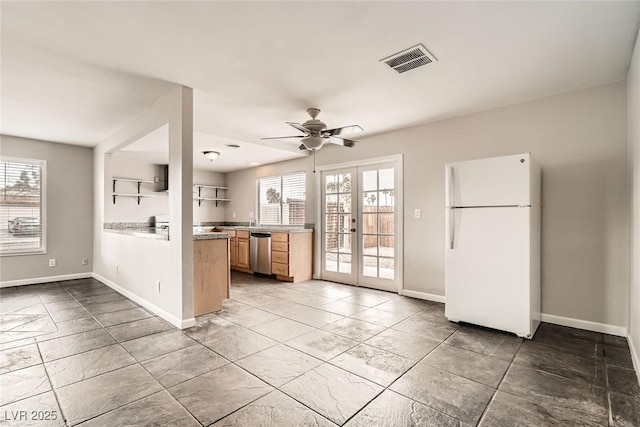 kitchen featuring visible vents, freestanding refrigerator, french doors, a healthy amount of sunlight, and stainless steel dishwasher