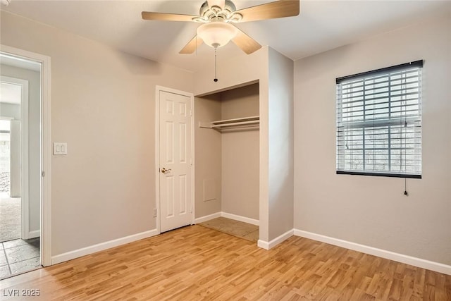 unfurnished bedroom featuring light wood finished floors, ceiling fan, baseboards, and a closet