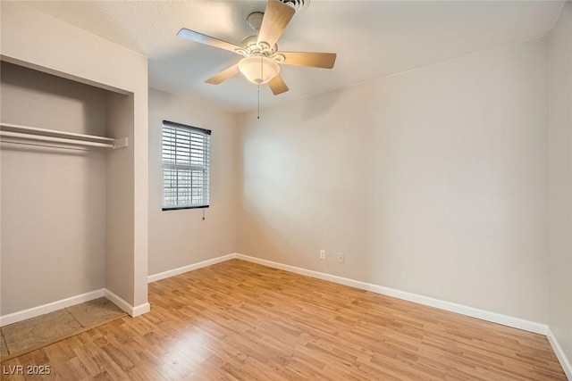 unfurnished bedroom with a ceiling fan, a closet, baseboards, and light wood finished floors