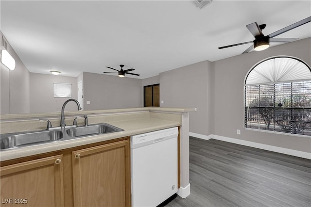 kitchen with visible vents, dark wood-style floors, white dishwasher, light countertops, and a sink