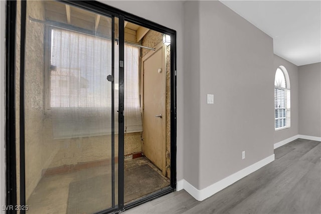 bathroom with wood finished floors and baseboards