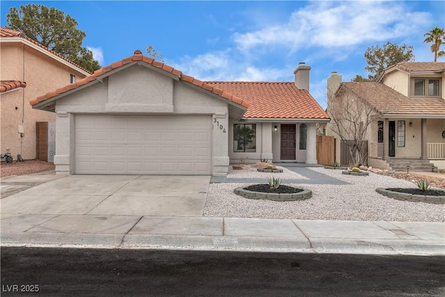 mediterranean / spanish-style house with a chimney, stucco siding, concrete driveway, a garage, and a tile roof