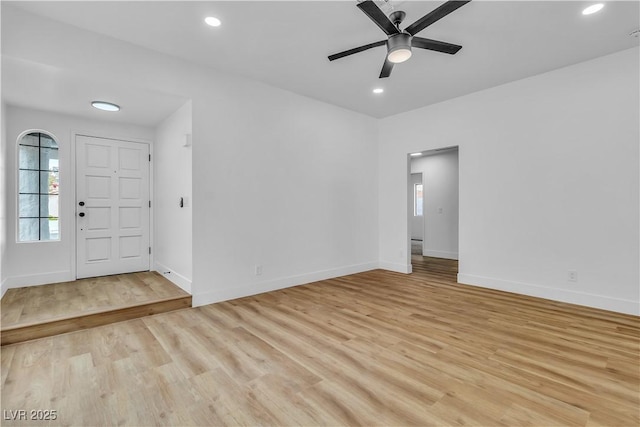 spare room featuring recessed lighting, a ceiling fan, baseboards, and light wood finished floors