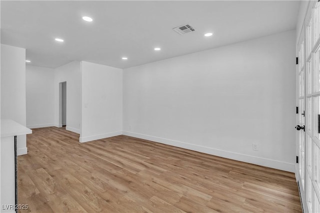 empty room with visible vents, recessed lighting, and light wood-style floors