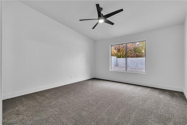 unfurnished room featuring vaulted ceiling, a ceiling fan, baseboards, and carpet floors