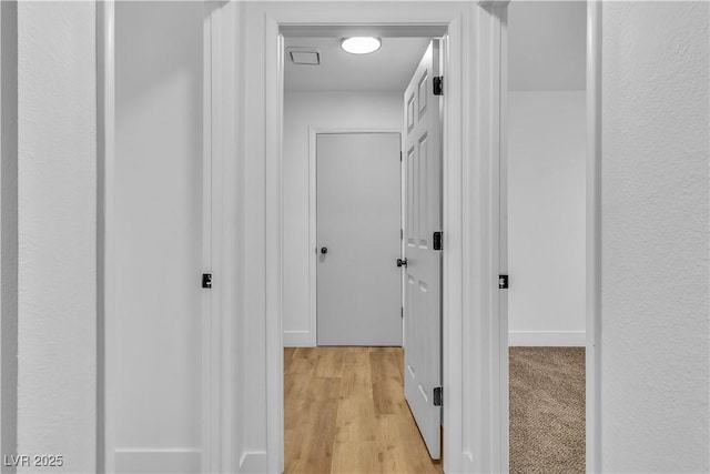 corridor with light wood-style floors