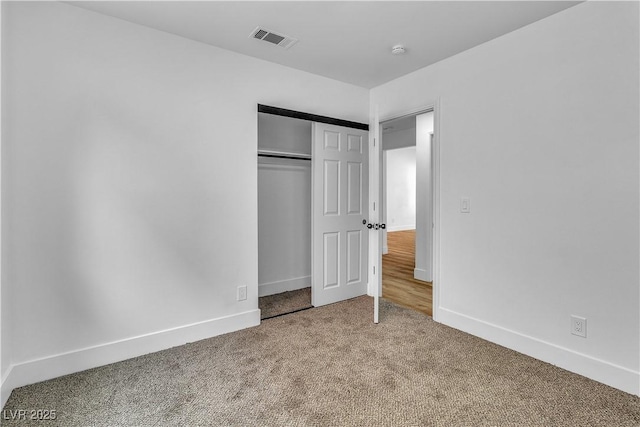 unfurnished bedroom with visible vents, baseboards, carpet, and a closet