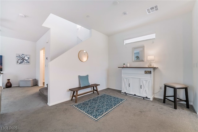 sitting room featuring baseboards, visible vents, and carpet flooring