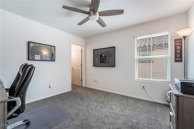 carpeted home office featuring ceiling fan and baseboards