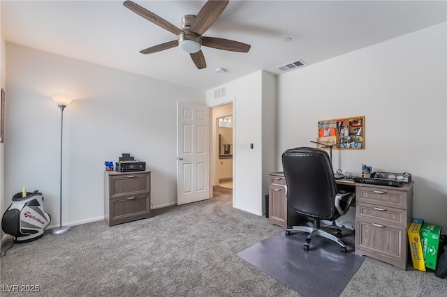 office space featuring baseboards, visible vents, and carpet flooring