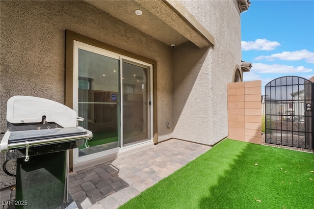 view of patio with a grill and fence