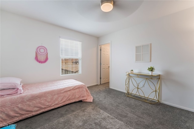 carpeted bedroom with ceiling fan and baseboards