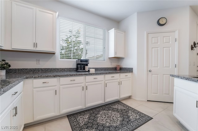 kitchen with white cabinetry and light tile patterned floors