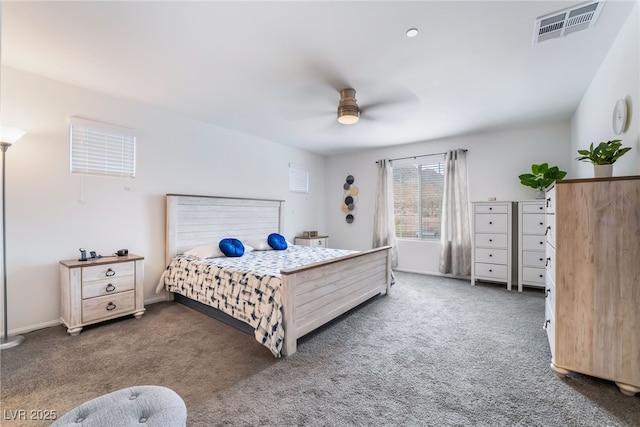 carpeted bedroom with a ceiling fan and visible vents