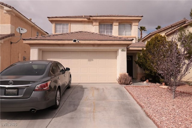 view of front of home with a garage, concrete driveway, a tiled roof, and stucco siding