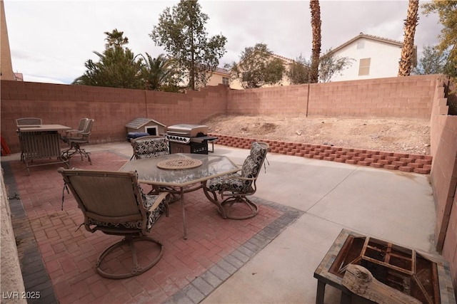 5032 Dancing Lights Ave, Las Vegas, NV 89130 - fenced backyard featuring outdoor dining area, area for grilling, and a patio