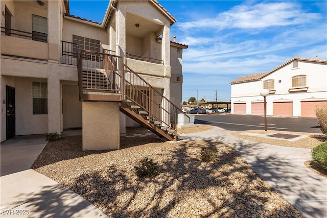 exterior space with community garages and stairway