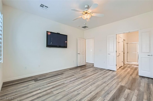 unfurnished bedroom featuring a ceiling fan, baseboards, visible vents, and light wood finished floors