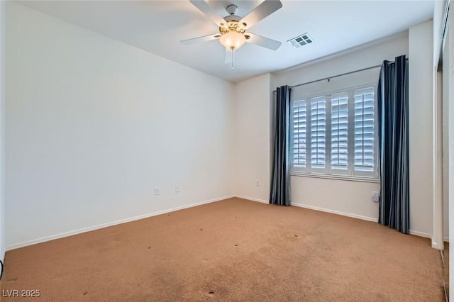 spare room with baseboards, visible vents, ceiling fan, and carpet flooring